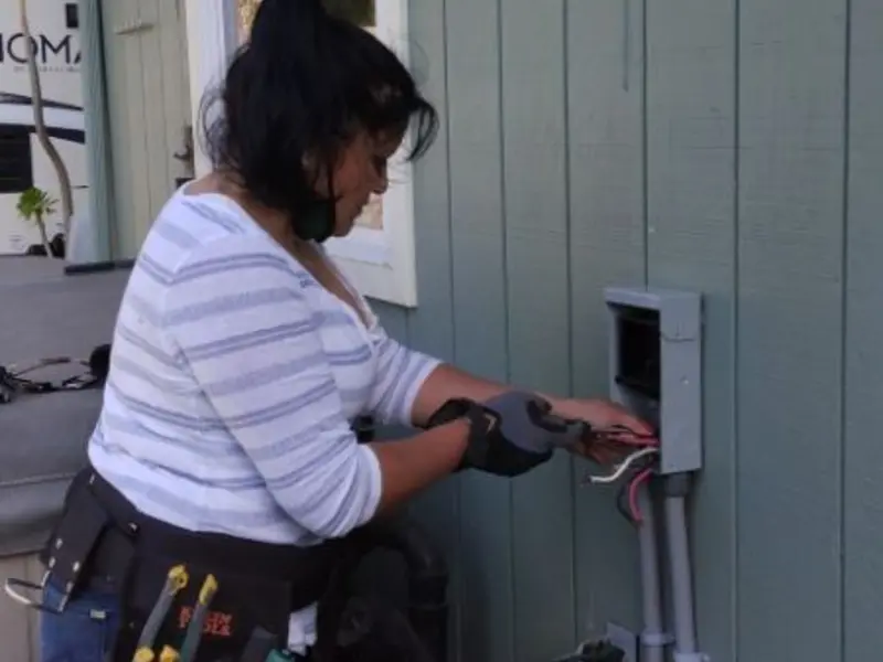 Licensed electrician wiring an exterior subpanel in Newfield